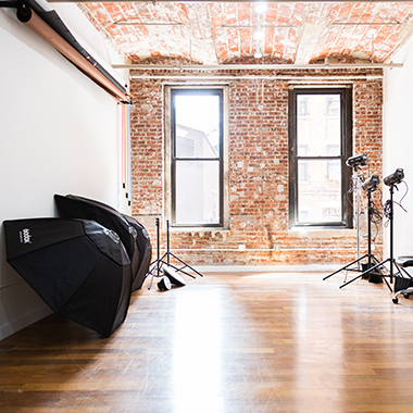 Thirteen photography studio filled with cameras and umbrellas