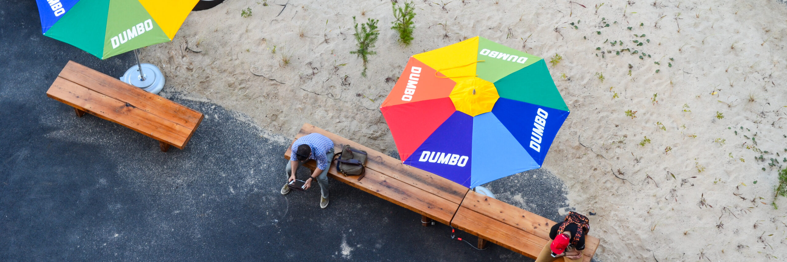 DUMBO Public Art Archive with colorful umbrellas and a couple of people sitting